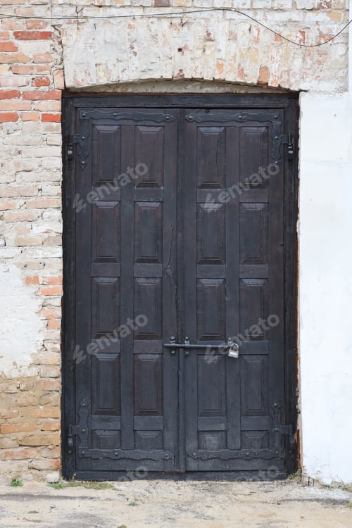 Preview: Very old solid door in brick stone wall of castle or fortress of 18th century