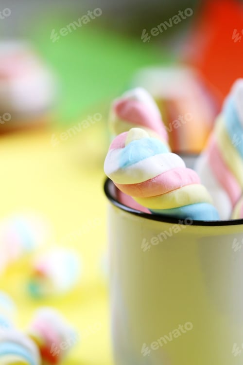 Preview: Sweet pastel colors of marshmallows in white cup closeup blur bright colorful background