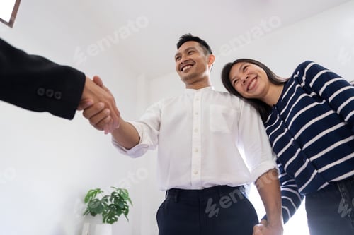 Preview: Couple asian handshake with a real estate agent after purchase a home