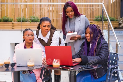 Preview: Young businesswomen of black ethnicity. In a business meeting in a cafeteria