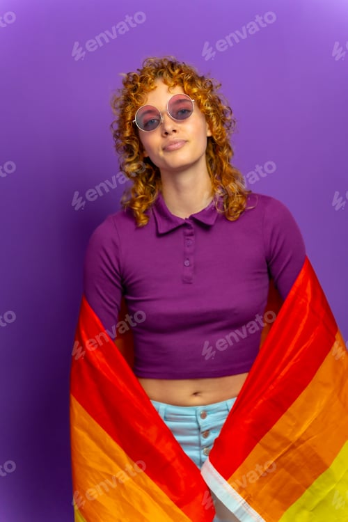 Preview: Lesbian woman wrapped in lgbt rainbow flag