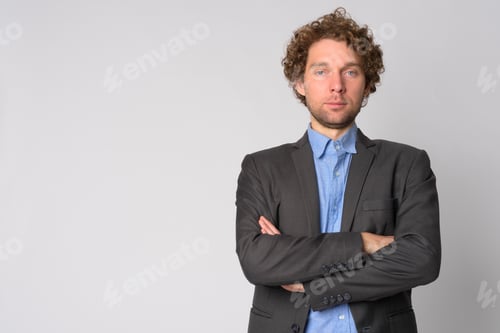 Confident Man in Suit with Arms Crossed