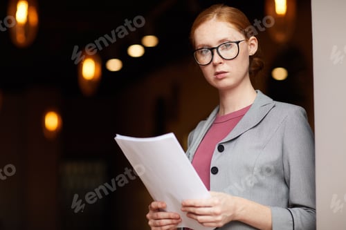 Preview: Serious businesswoman with document