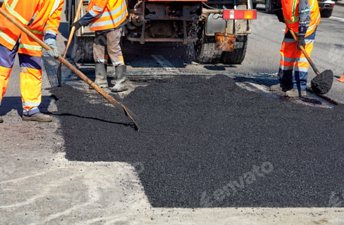 Preview: Road workers updating part of the road with fresh hot asphalt and smoothes it for repair