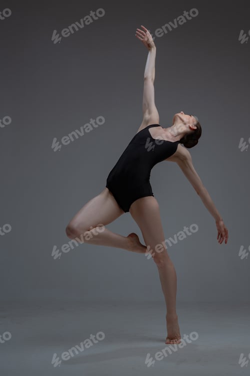 Preview: Staying on one leg ballerina against gray background