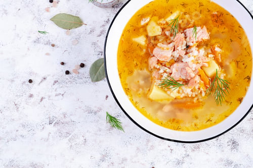 Preview: Fish soup with salmon, vegetables and rice in white bowl. Salmon soup.