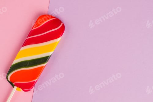 Preview: Sweet multicolored lollipop on colorful paper.