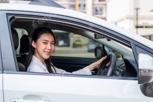 Preview: Portrait of Asian beautiful woman driver sitting in car before driving.