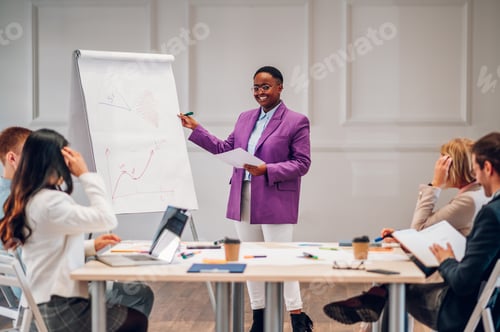 Preview: African american businesswoman holding a presentation during a meeting in an office