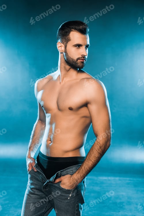 Preview: sexy muscular man in black underwear and jeans posing on blue smoky background