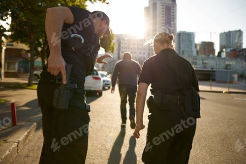 Preview: Patrol officers preparing weapon while chasing offender on urban street