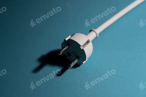 Preview: Electric plug on blue background. Increase in electricity costs for private and business customers,