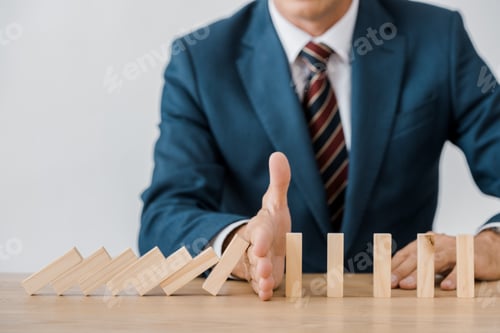 Preview: close up of businessman with blocks wood game in office, insurance concept