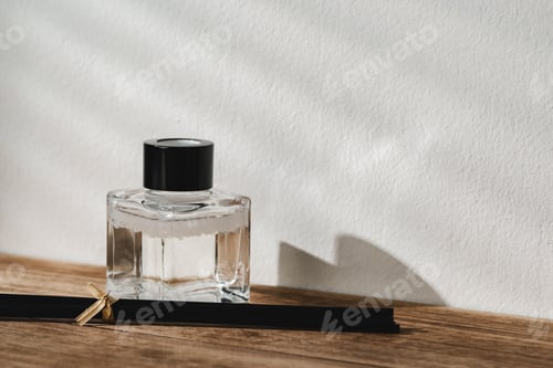 Preview: Elegant Perfume Bottle Bathed in Sunlight on a Wooden Surface