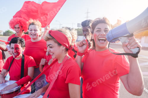 Preview: Fan shouting through the megaphone along with the other teammates cheering for her team