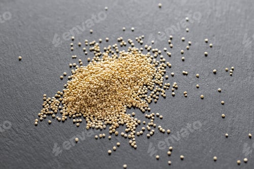 Preview: You can see in the image a pile of quinoa grains, on a blackboard, seen from above