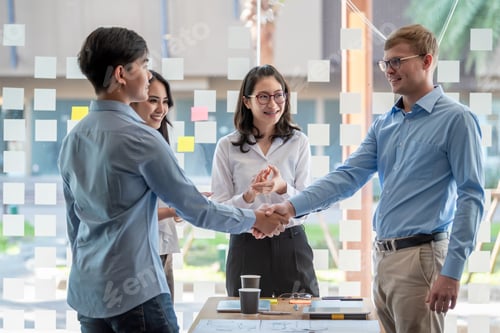 Preview: Young asian business people handshake.
