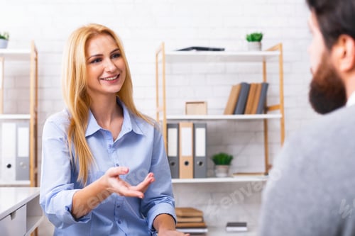 Preview: Blonde Woman Talking to Man in Office