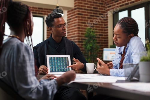 Preview: Business development company project manager pointing financial analysis on tablet