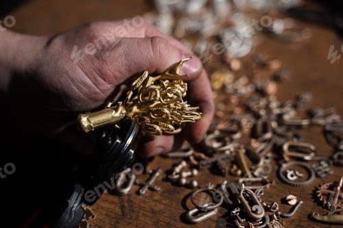 Preview: Jeweler cutting cast jewelry parts from metal tree structure.