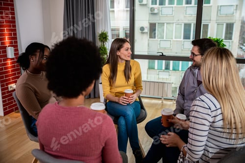 Preview: Diverse group of people sitting in circle in group therapy session.