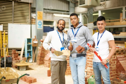 Preview: Portrait of three male college students in bricklaying workshop