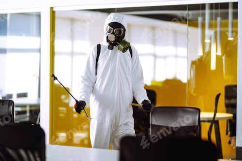 Preview: Disinfecting of office to prevent COVID-19, Man in protective hazmat suit with spray chemicals.