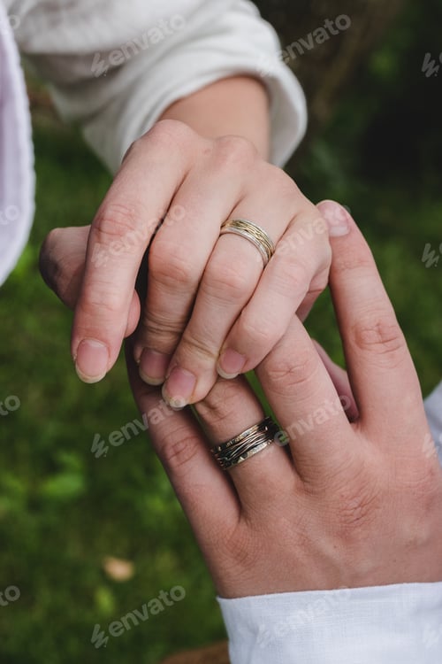 Preview: Hands, wife and broom, wedding rings. Boho wedding, folk style, earth tones.