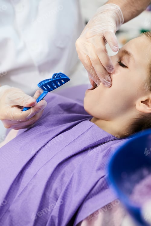 Preview: Close-up of orthodontist taking dental impression of small girl's teeth at dentist's office.