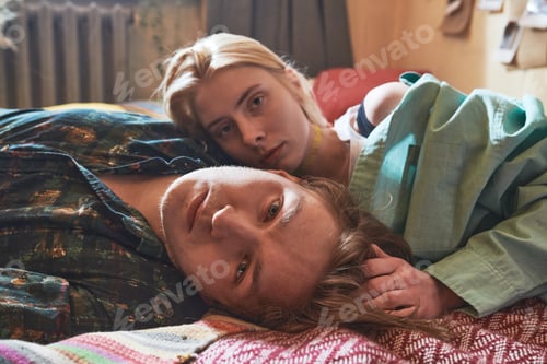 Preview: Young couple relaxing on bed