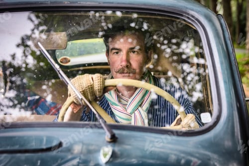 Preview: Man nostalgically driving a vintage truck through the countryside
