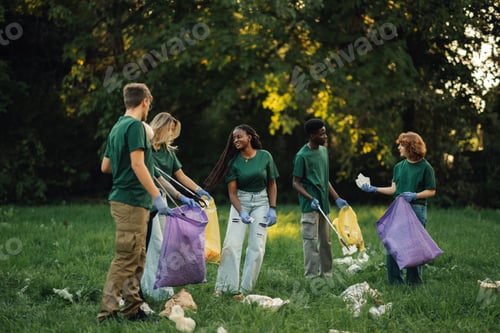 Preview: Group of volunteers picking up trash in park