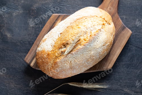 Preview: freshly baked bread on wooden cutting board