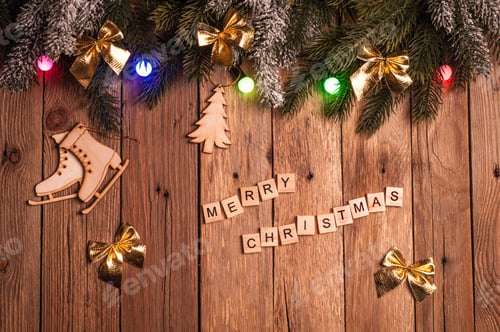 Preview: Christmas fir tree with decoration and christmas colorful lights on dark wooden background. Top view