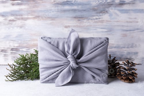 Preview: Christmas wrapped gift by reusable linen fabric in eco style.