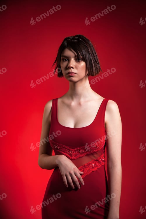 Preview: Portrait teen girl wear red trendy dress with stylish hairstyle at red background