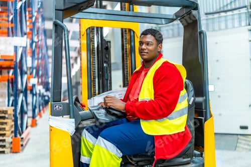 Preview: Overweight latin man working driving forklift in a warehouse