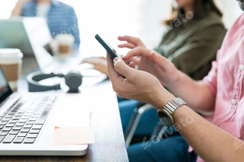 Preview: Entrepreneur Text Messaging On Cellphone At Office