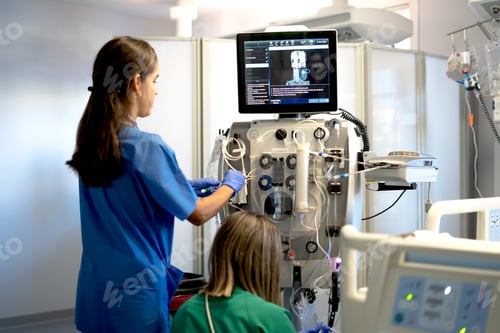 Preview: Medical team preparing dialysis equipment in a hospital setting