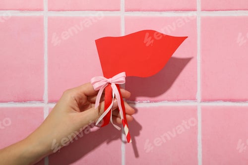 Preview: Red flag, accessory for Valentine's Day on a pink background.