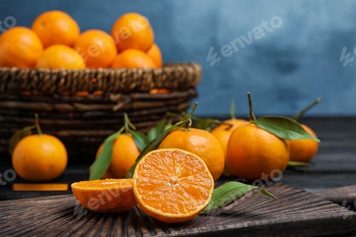 Preview: Fresh juicy cut tangerine on wooden board