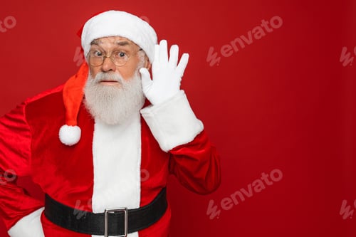 Preview: Santa Claus trying to overhear what you say isolated shine vibrant red background, copy space