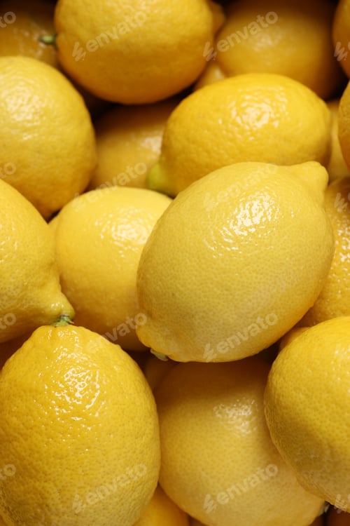 Preview: Fresh lemons as background, closeup. Citrus fruit