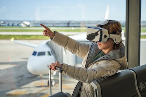 Preview: Curious child pointing away while experiencing virtual reality i