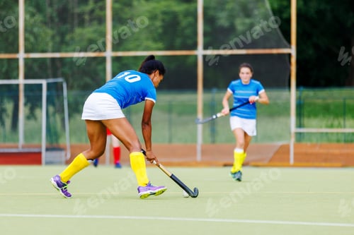 Preview: Young woman field hockey player leading the ball in attack