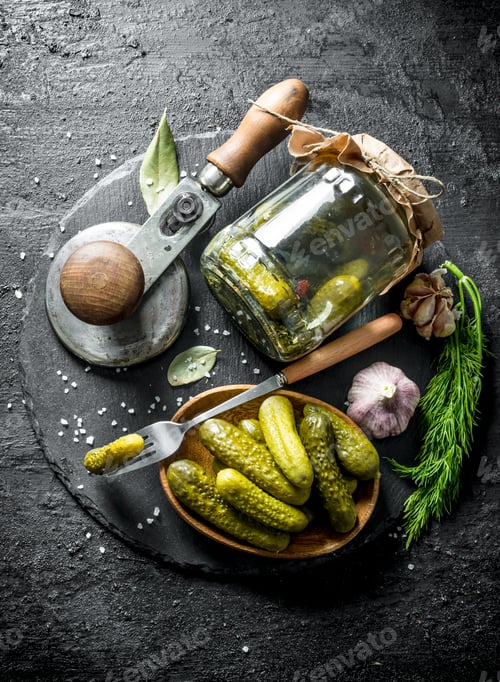 Preview: Homemade preserved cucumbers on a stone Board.