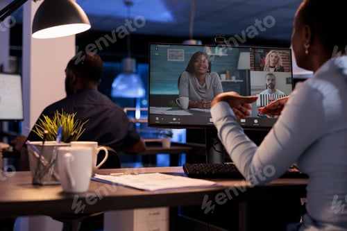 Preview: Businesswoman talking to colleagues on remote videoconference