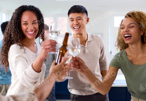 Preview: Group Of Friends At Home In Kitchen With Drinks Making Food For Party