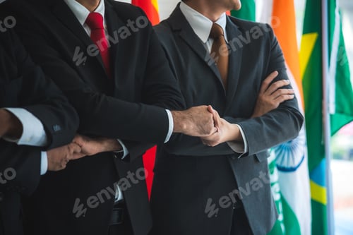 Preview: Business people shake hands, international flag background