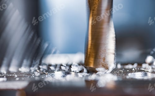 Preview: Drilling process with shavings close-up at the workplace in workshop